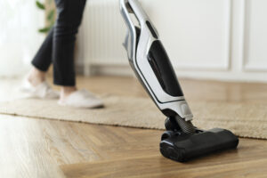 Housewife Vacuuming Parquet Floor