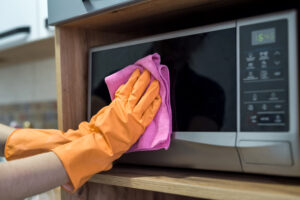 Woman While Cleaning Surface Kitchen Desk With Sponge Her Rubber Gloves Housework