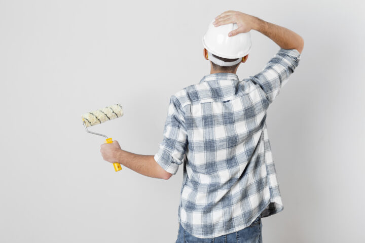 Back View Worker Holding Paint Roller