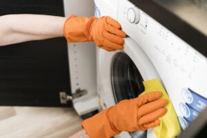 High Angle Woman Cleaning Washing Machine