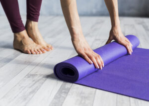 Woman Rolling Her Yoga Mat