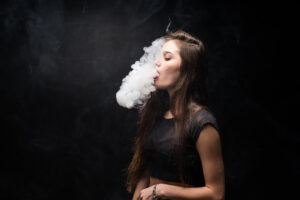 Young Woman Black Smokes Electronic Cigarette Dark Wall