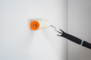 Painter Painting Wall With Roller