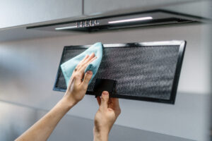 Woman Cleaning Aluminum Mesh Filter Wipe Dirty Part Black Metal Kitchen Hood