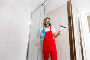 Man Cleaning Shower Cabin